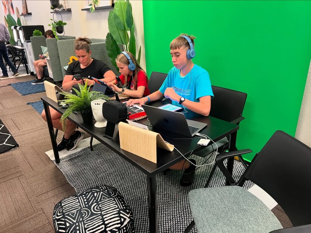 Participating kids and their mother experimenting with a green screen and video-making