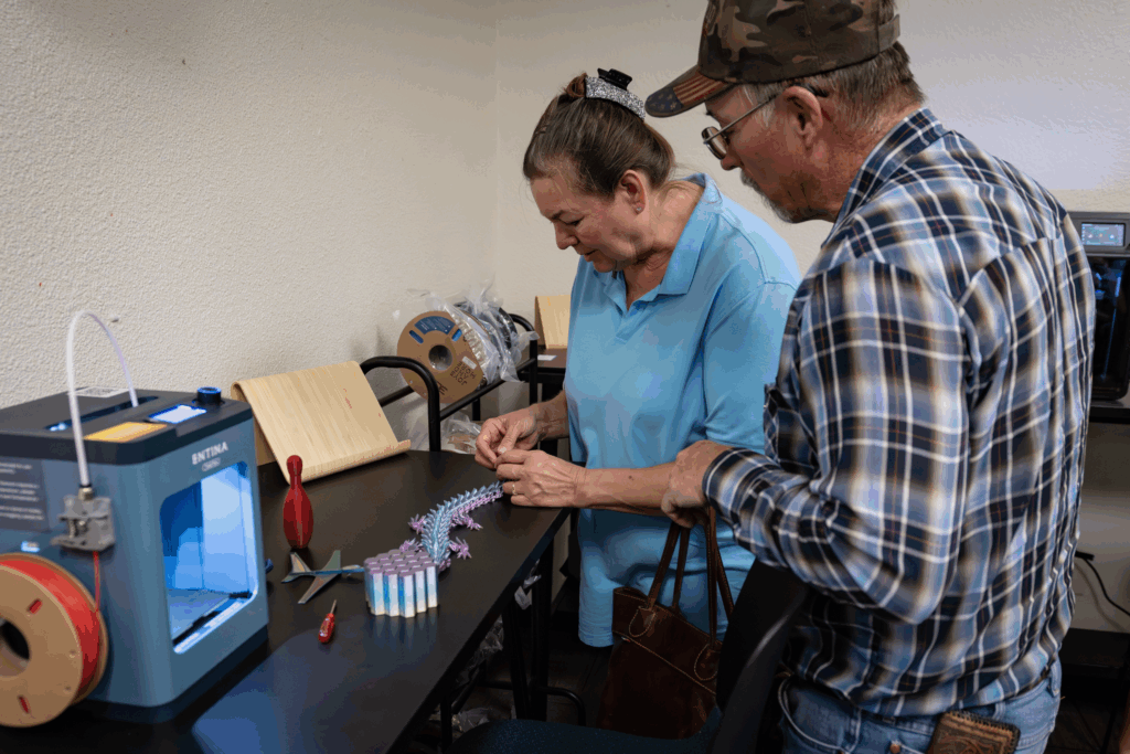 Two attendees explore Hive equipment