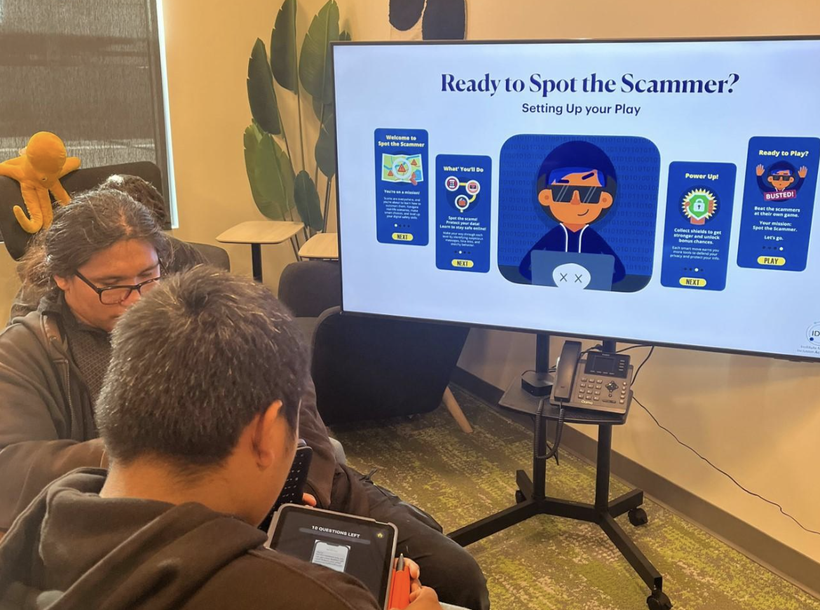 People viewing the Spot the Scammer training at a Hive